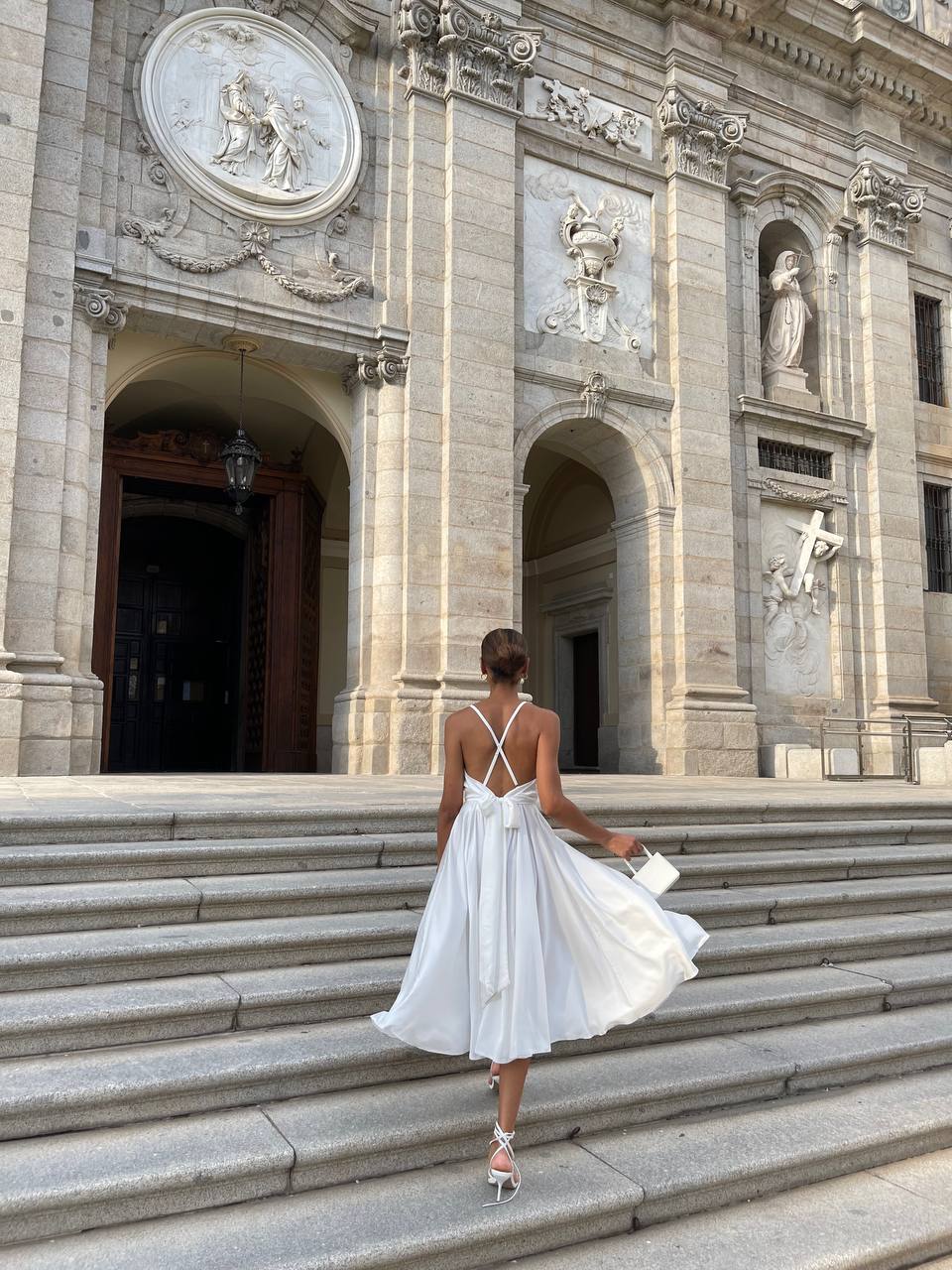 Milk dress with an open back and a lush skirt