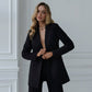 A black suit with a straight jacket and wide trousers 