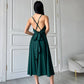 An emerald dress with an open back and a lush skirt