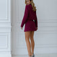 A burgundy suit with a crop jacket and skirt-shorts