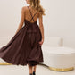 Brown dress with an open back and a lush skirt