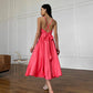 Coral dress with an open back and a lush skirt