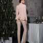 A beige suit with a peplum jacket and tapered trousers