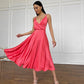 Coral dress with an open back and a lush skirt