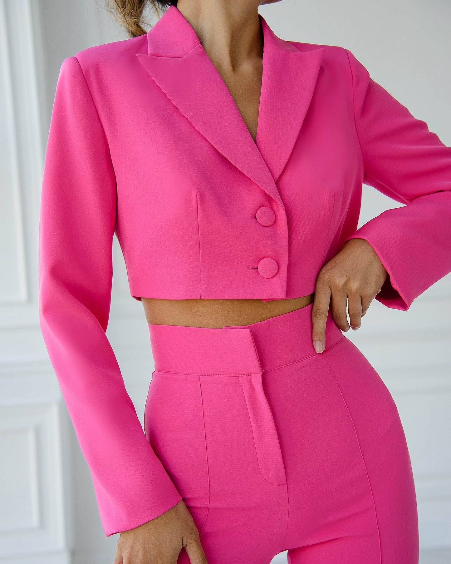 A crimson suit with a crop jacket and flared pants