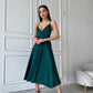 An emerald dress with an open back and a lush skirt