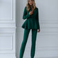 A green suit with a peplum jacket and tapered trousers