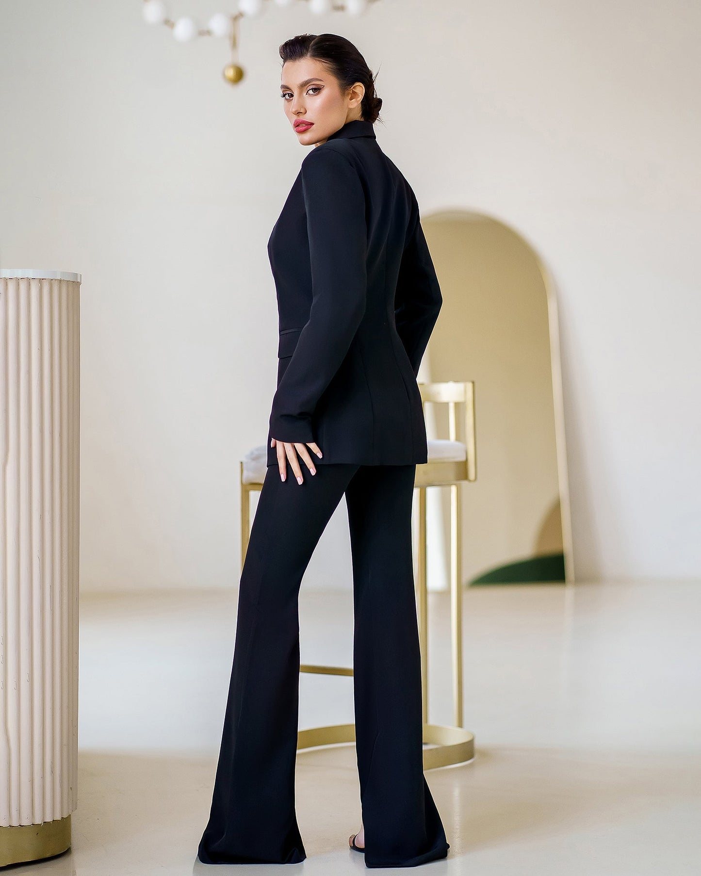 Black suit jacket and flared pants with slits