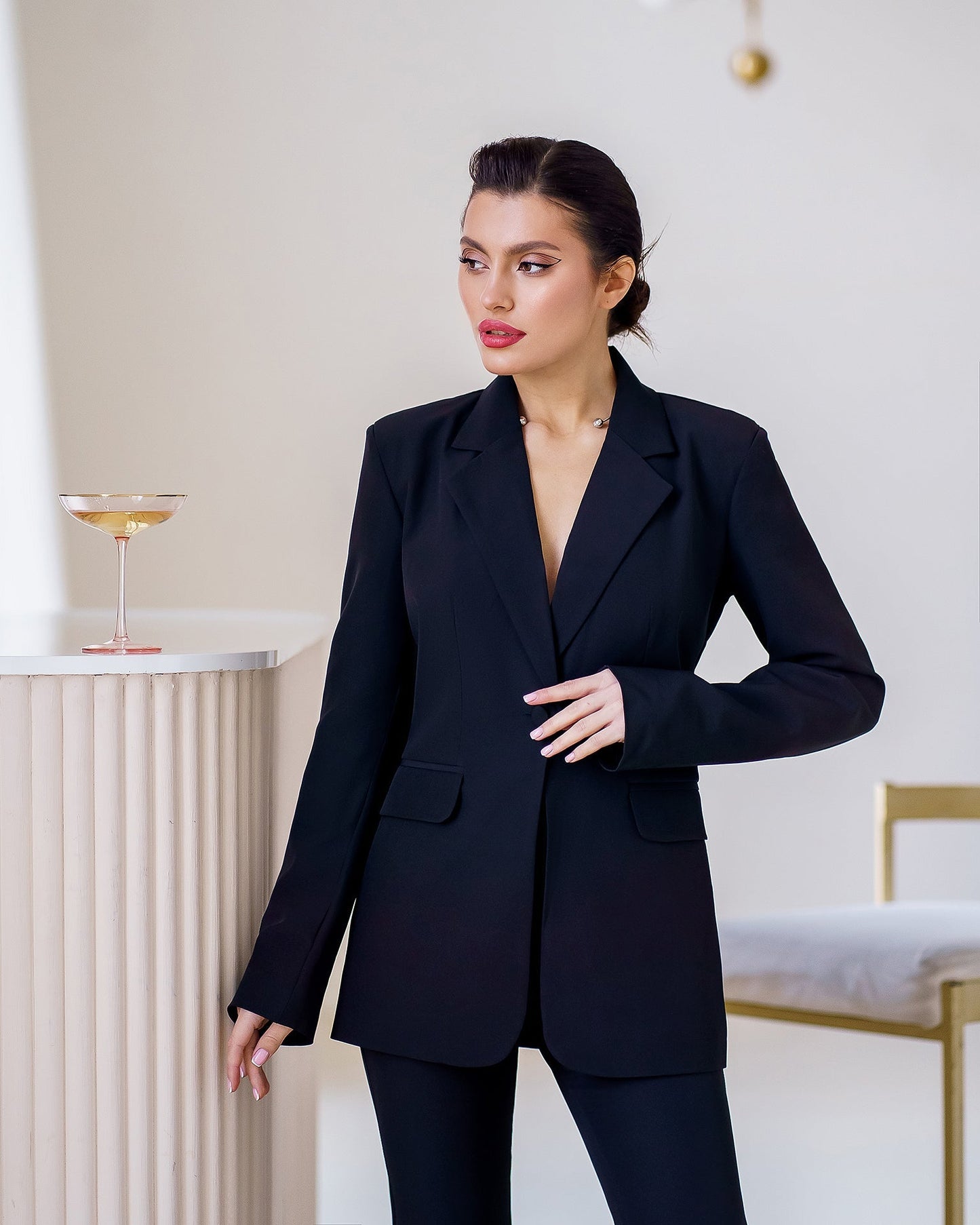 Black suit jacket and flared pants with slits