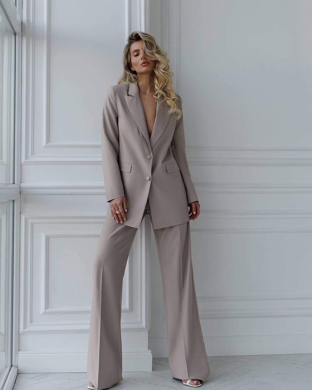 A beige suit with a straight jacket and wide trousers