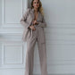 A beige suit with a straight jacket and wide trousers