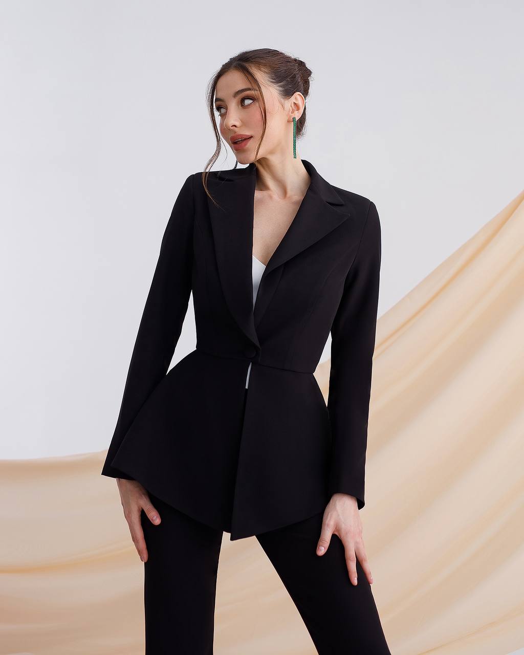 A black suit with a peplum jacket and flared pants