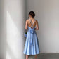 Blue dress with an open back and a lush skirt