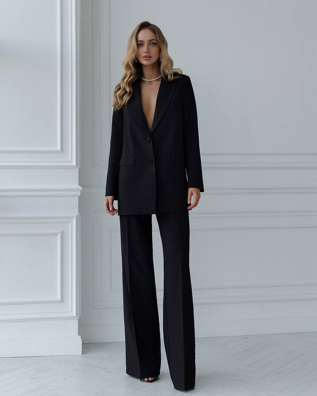 A black suit with a straight jacket and wide trousers 