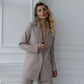 A beige suit with a straight jacket and wide trousers