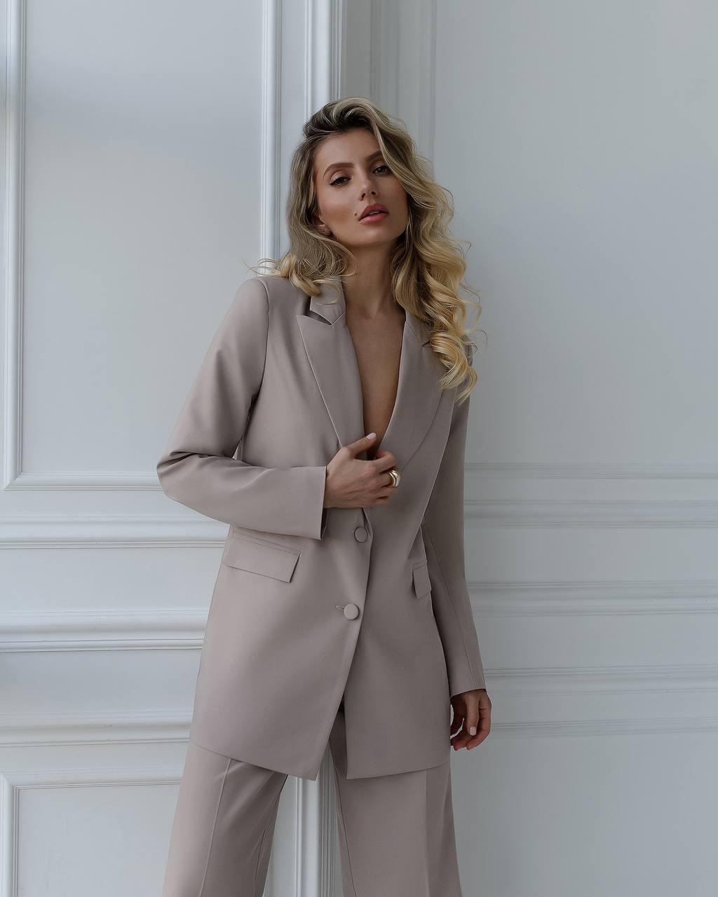 A beige suit with a straight jacket and wide trousers