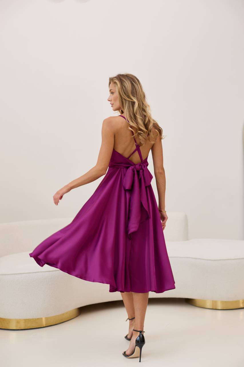 A dress with an open back and a lush skirt