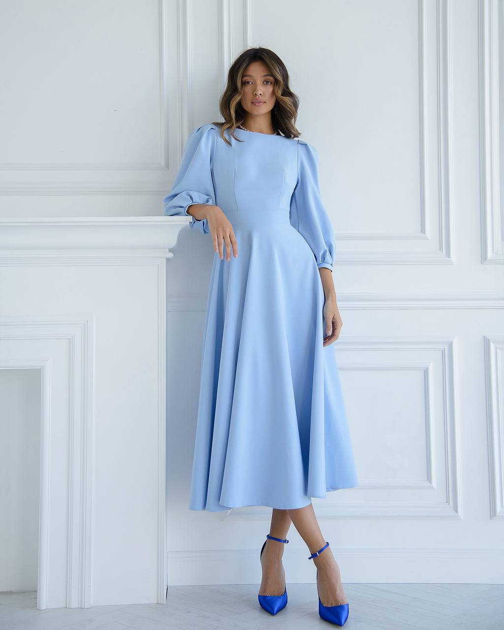 Blue midi dress with a full skirt and a bow