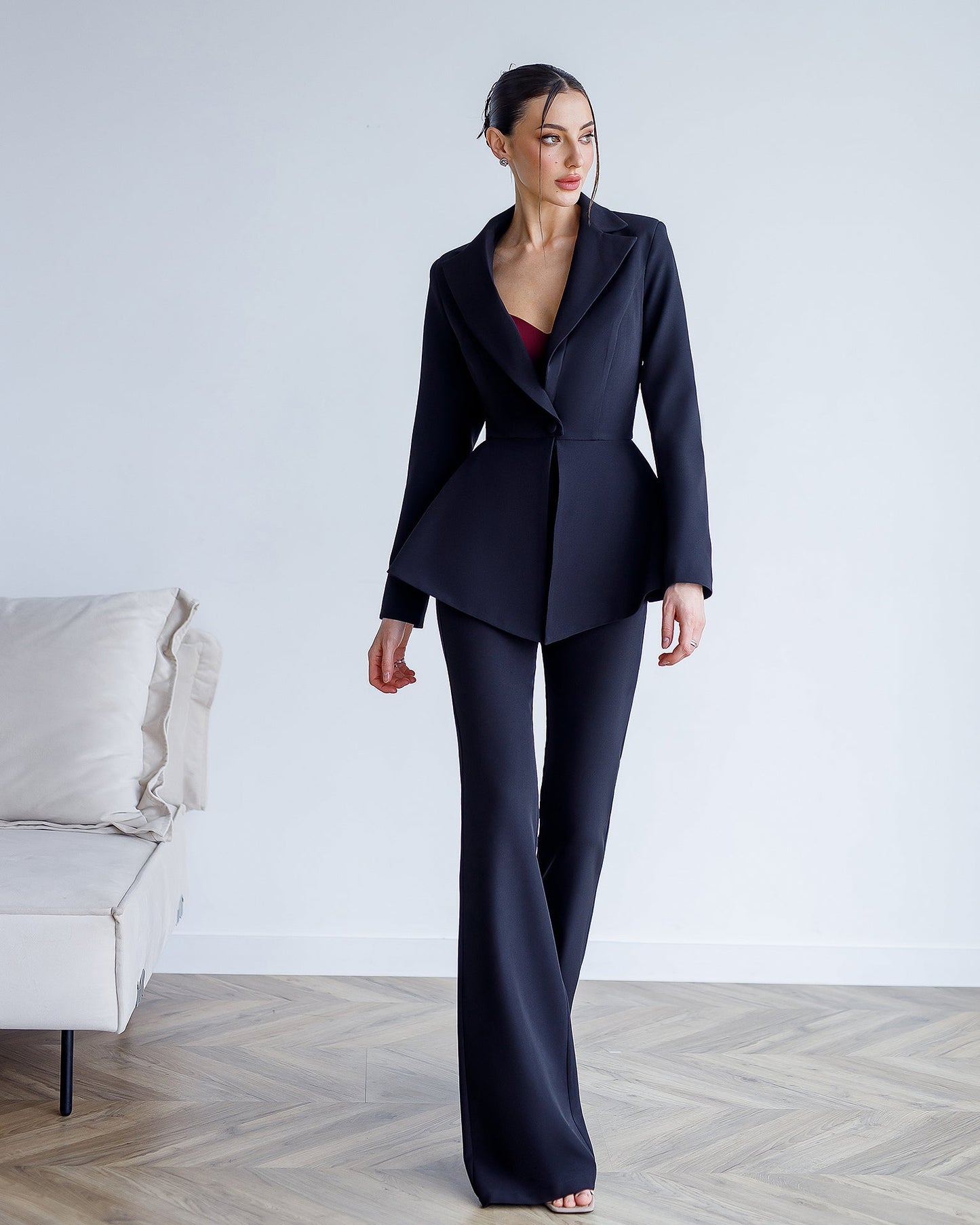 A black suit with a peplum jacket and flared pants