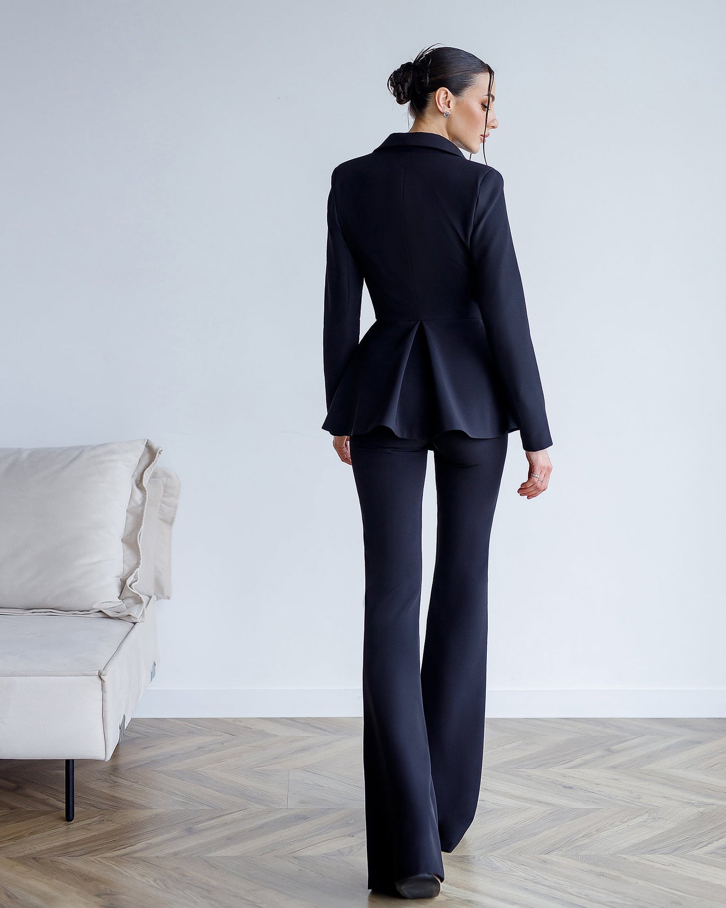 A black suit with a peplum jacket and flared pants