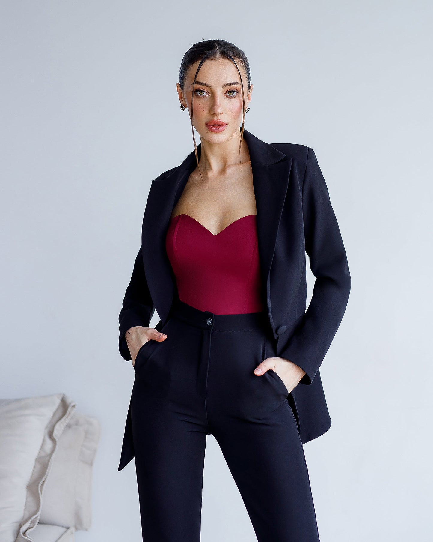 A black suit with a peplum jacket and flared pants