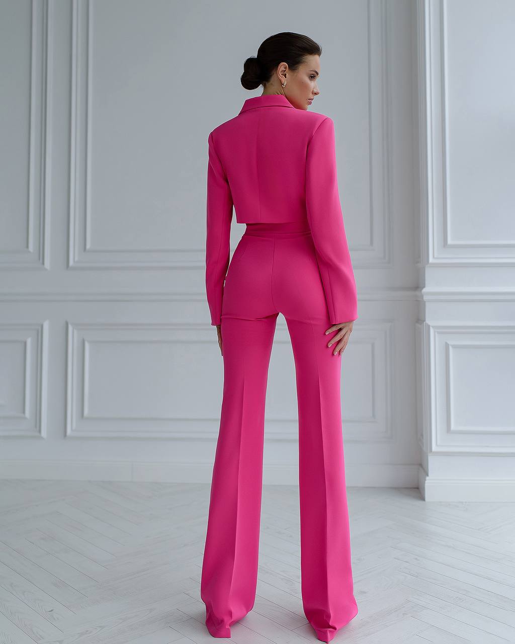 A crimson suit with a crop jacket and flared pants