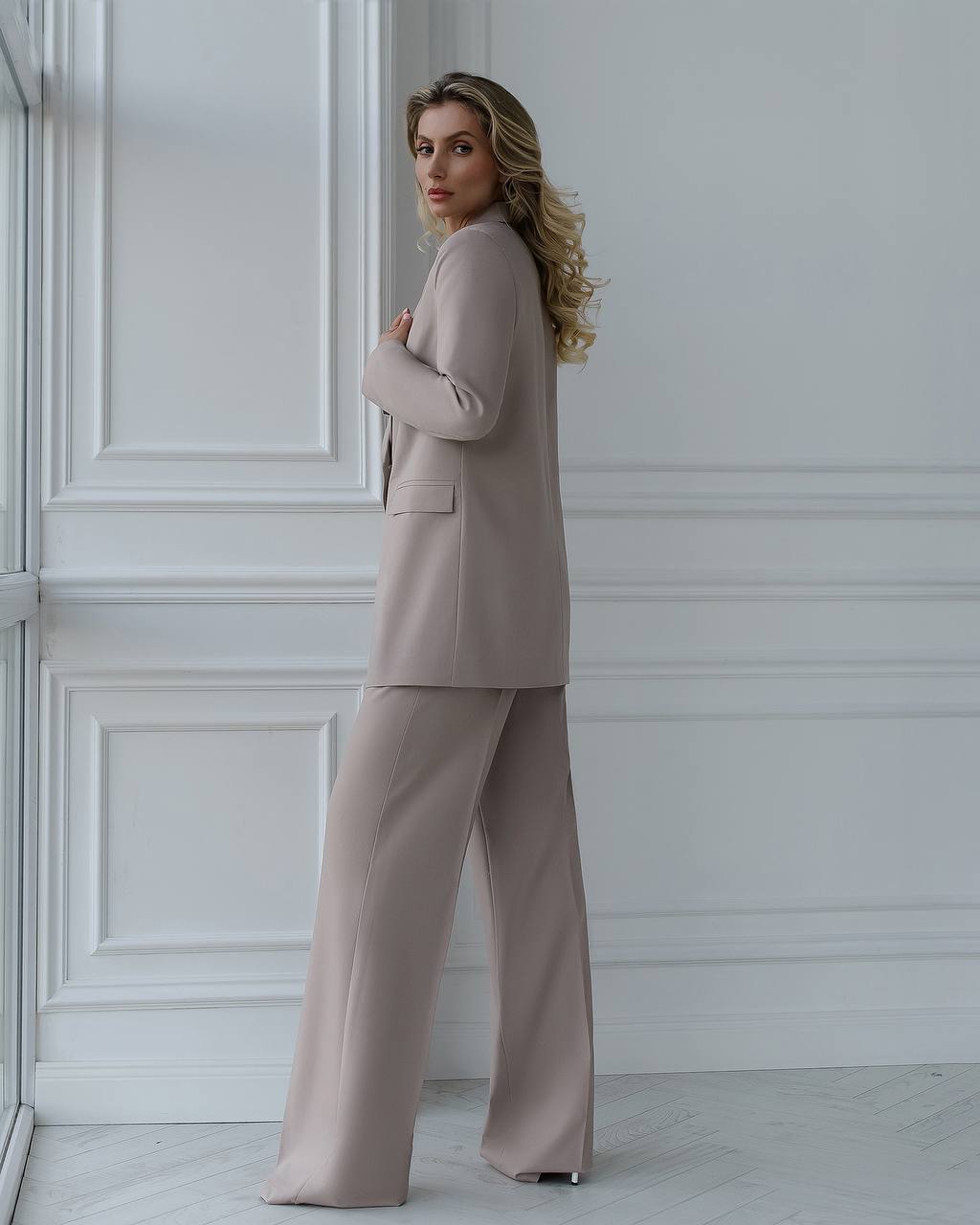 A beige suit with a straight jacket and wide trousers