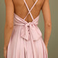 Soft pink dress with an open back and a lush skirt