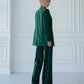 A green suit with a straight jacket and wide trousers 