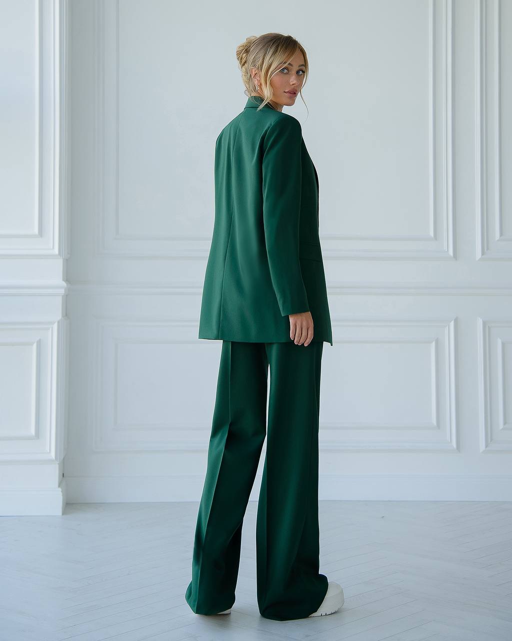 A green suit with a straight jacket and wide trousers 