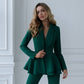 A green suit with a peplum jacket and tapered trousers