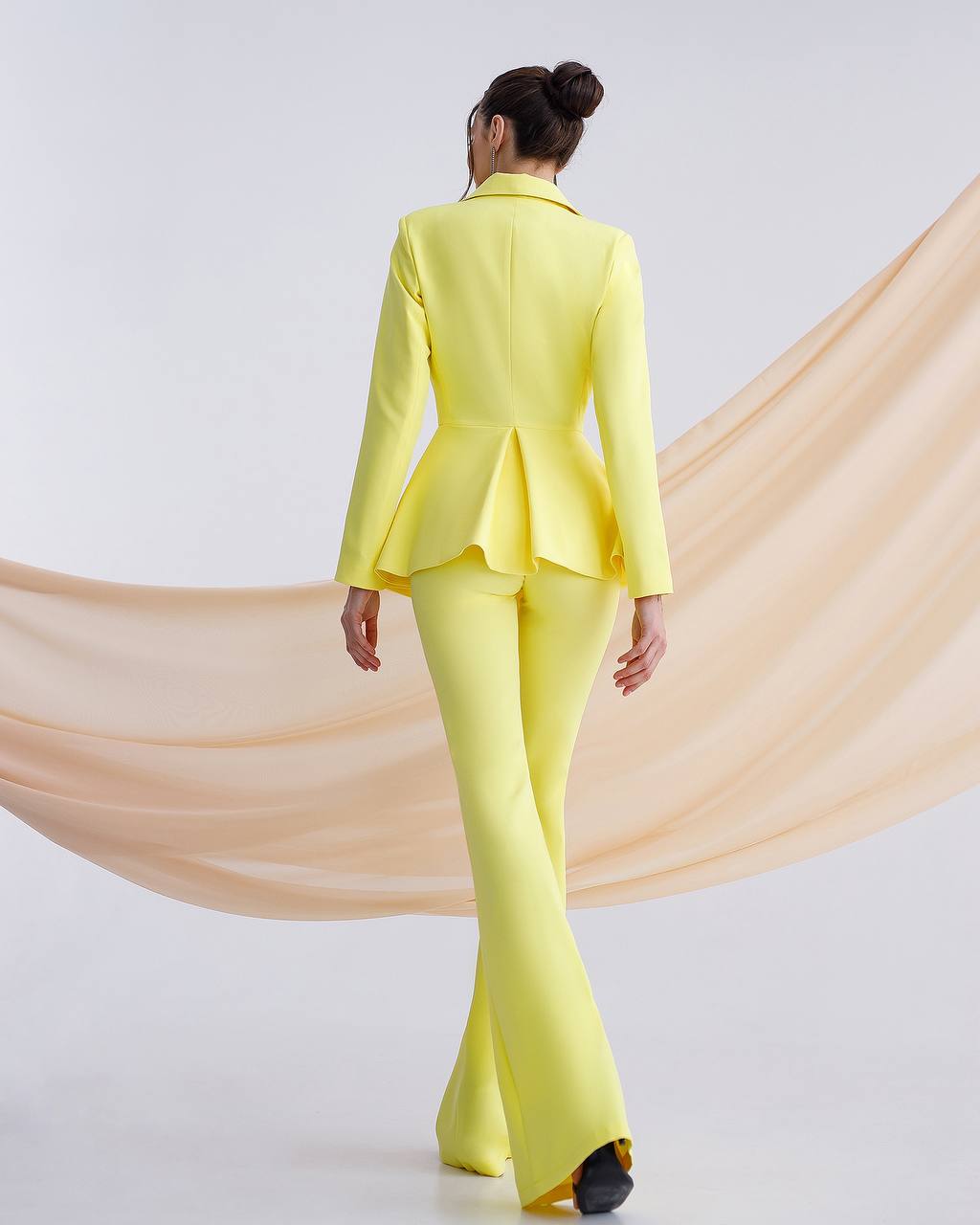 A yellow suit with a peplum jacket and flared pants