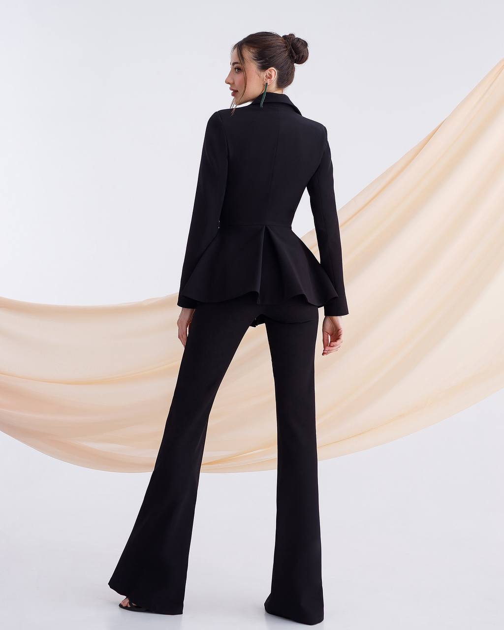 A black suit with a peplum jacket and flared pants