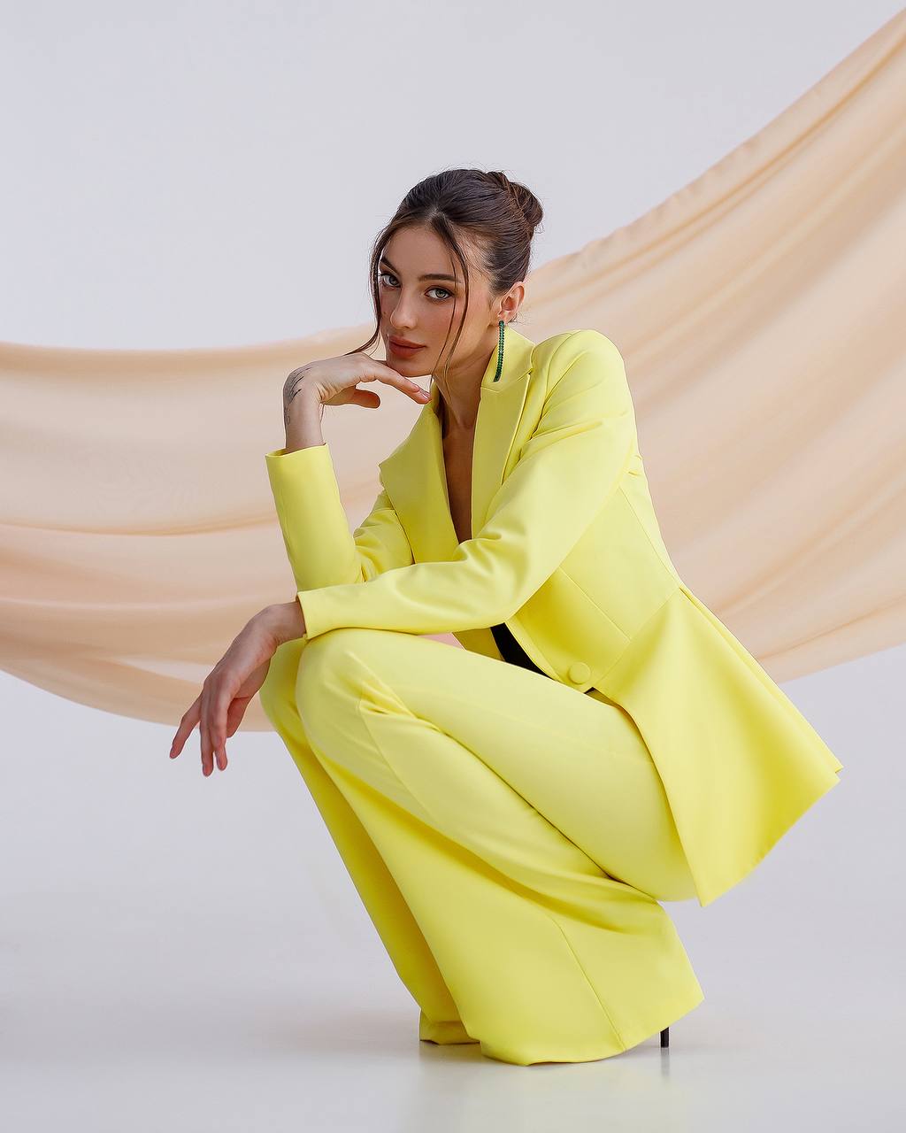 A yellow suit with a peplum jacket and flared pants