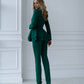 A green suit with a peplum jacket and tapered trousers