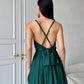 An emerald dress with an open back and a lush skirt