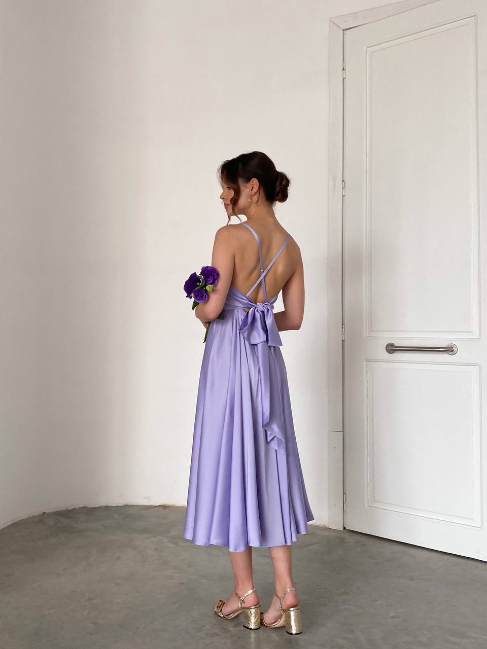 Lavender dress with an open back and a lush skirt