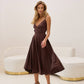 Brown dress with an open back and a lush skirt