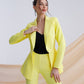 A yellow suit with a peplum jacket and flared pants