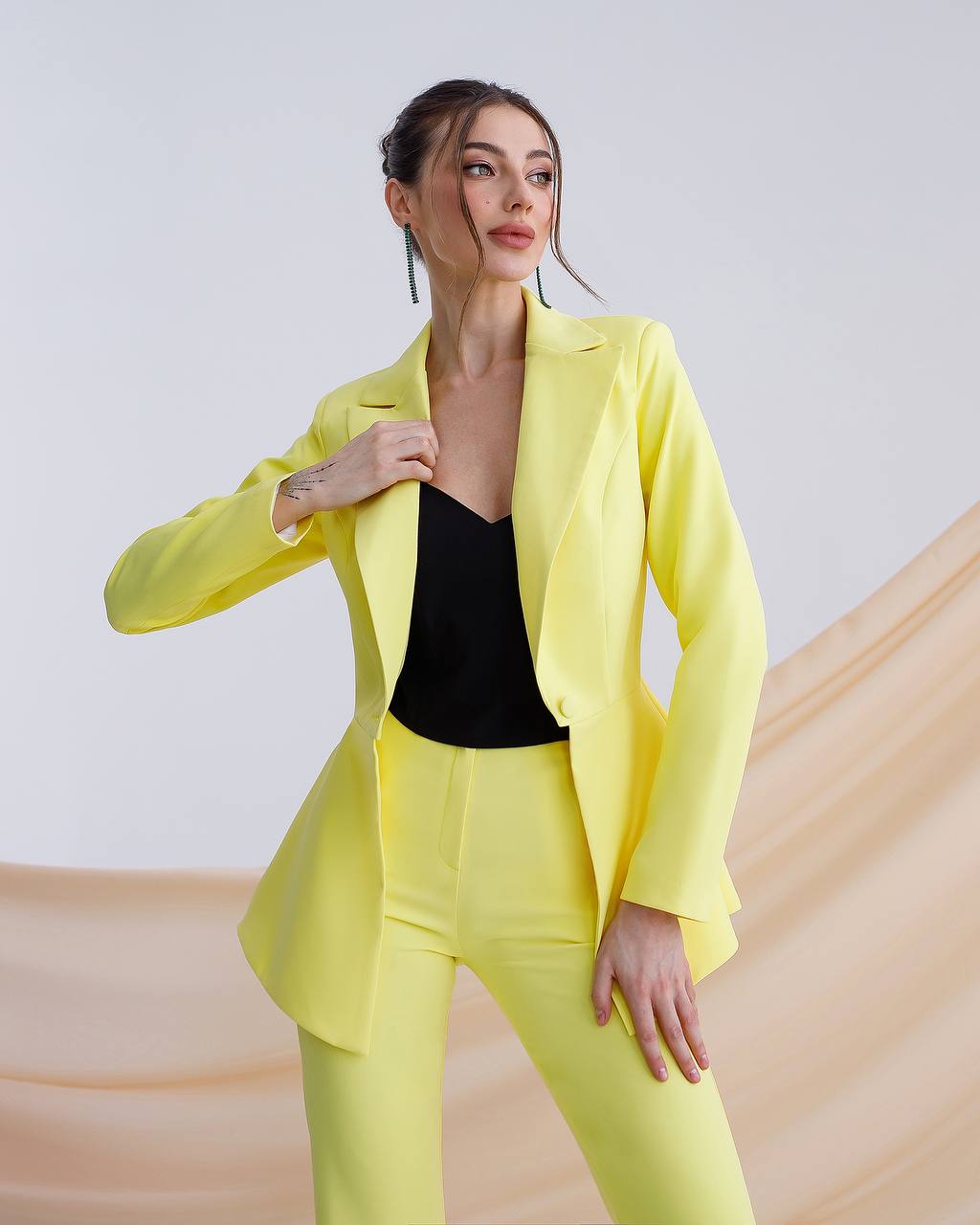 A yellow suit with a peplum jacket and flared pants