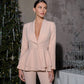 A beige suit with a peplum jacket and tapered trousers