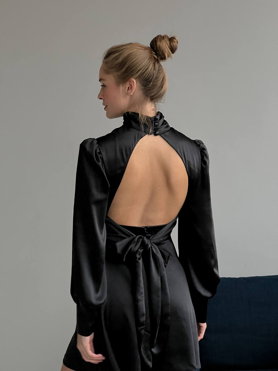 Black mini dress with open back and bow