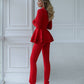 A red suit with a peplum jacket and tapered trousers