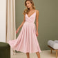 Soft pink dress with an open back and a lush skirt