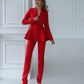 A red suit with a peplum jacket and tapered trousers