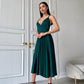 An emerald dress with an open back and a lush skirt