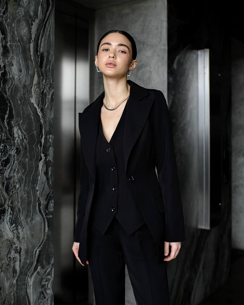 Black three-piece suit with vest