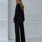 A black suit with a straight jacket and wide trousers 