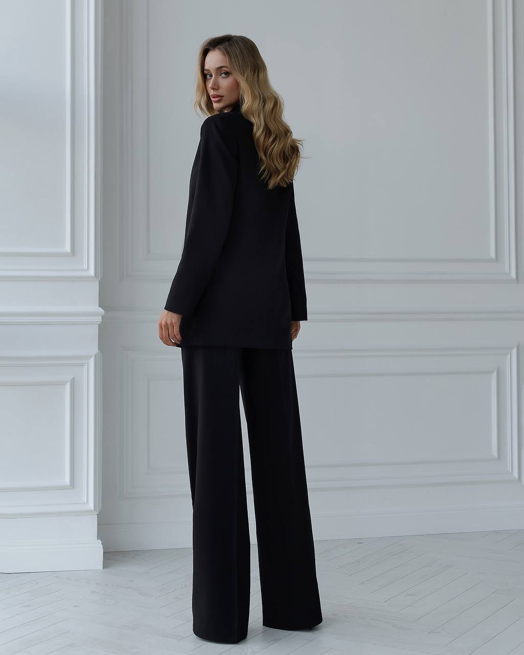 A black suit with a straight jacket and wide trousers 