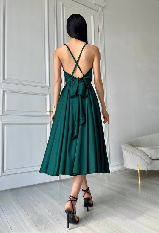 An emerald dress with an open back and a lush skirt